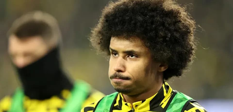 Player in training gear on sidelines during match