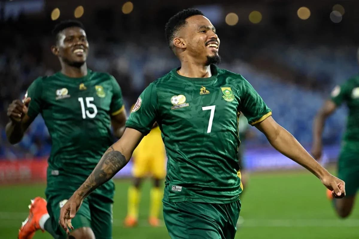 Player celebrating a goal with teammates on field Player celebrating a goal with teammates on field