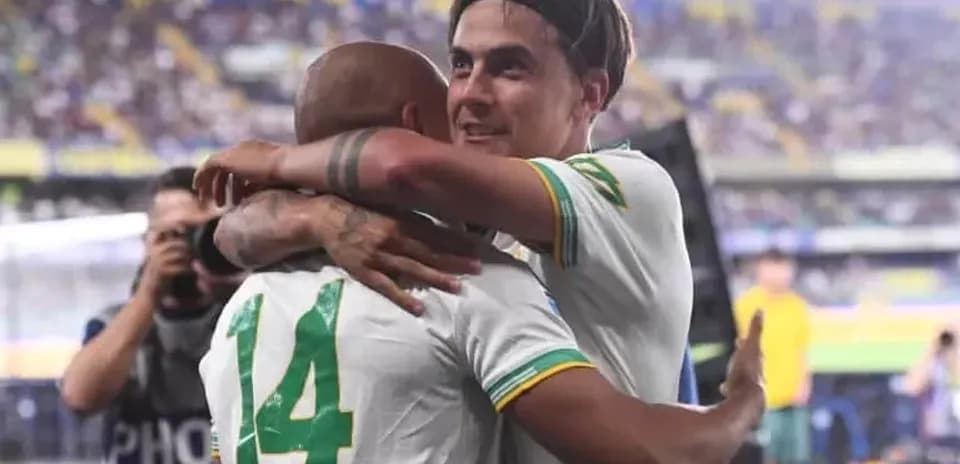 Two players celebrating with an embrace on field