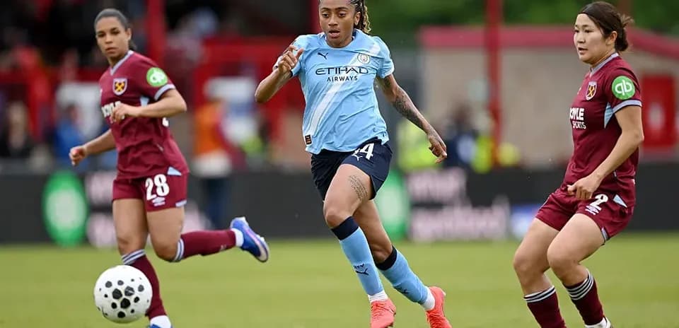 Player in blue sprinting with ball during match