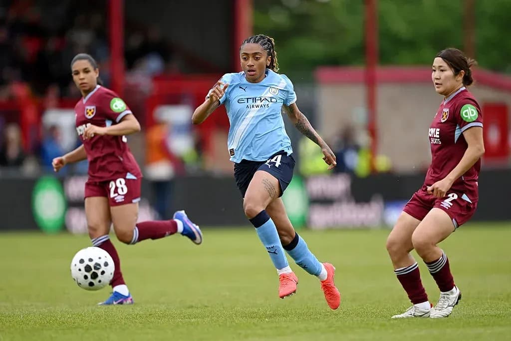 Player in blue sprinting with ball during match