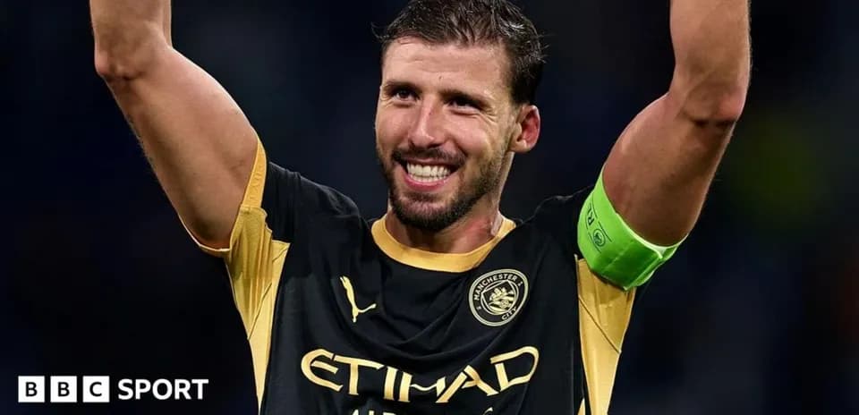 Player celebrating with raised arms wearing captain's armband