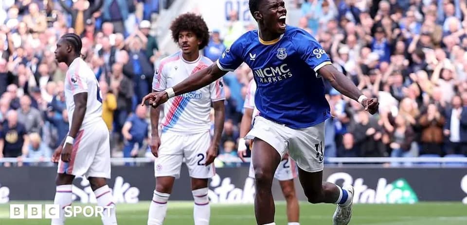 Everton player celebrating goal with fans in background