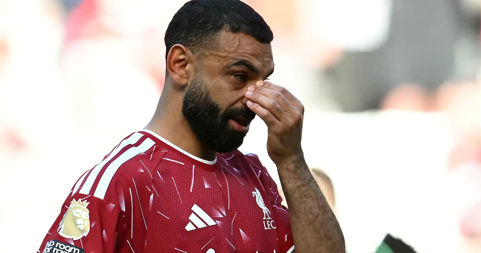 Player wiping brow during match on field