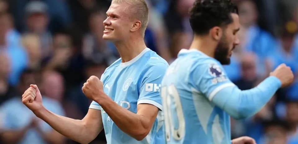Erling Haaland celebrating a goal with teammate