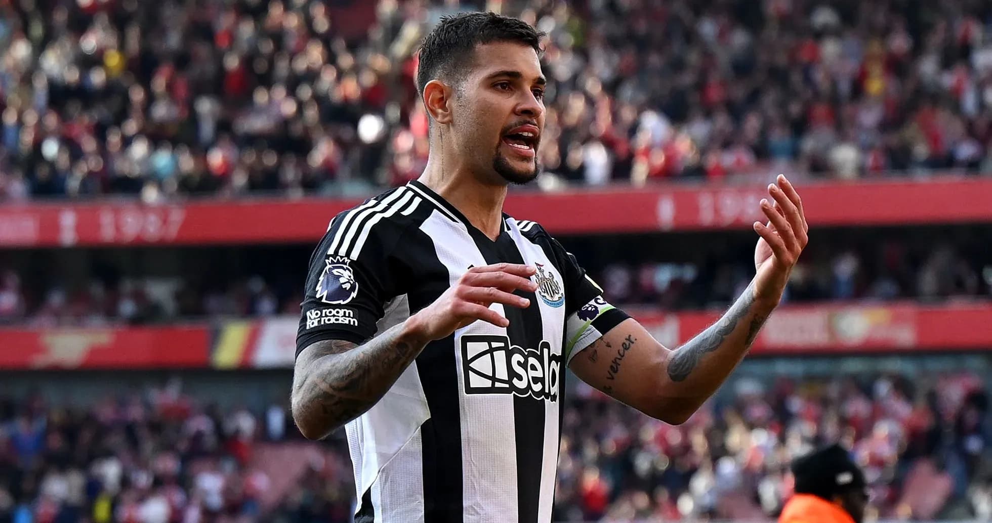 Newcastle player gesturing during match at stadium