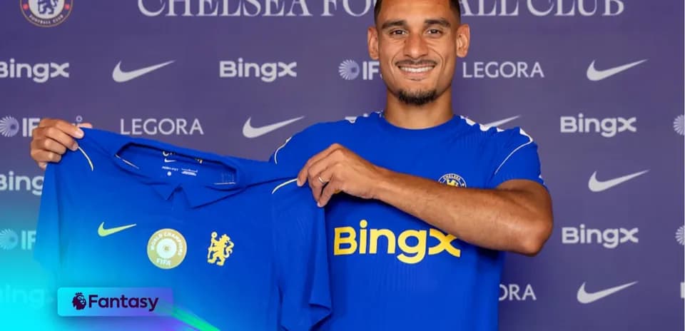 Player holding Chelsea FC jersey at press event