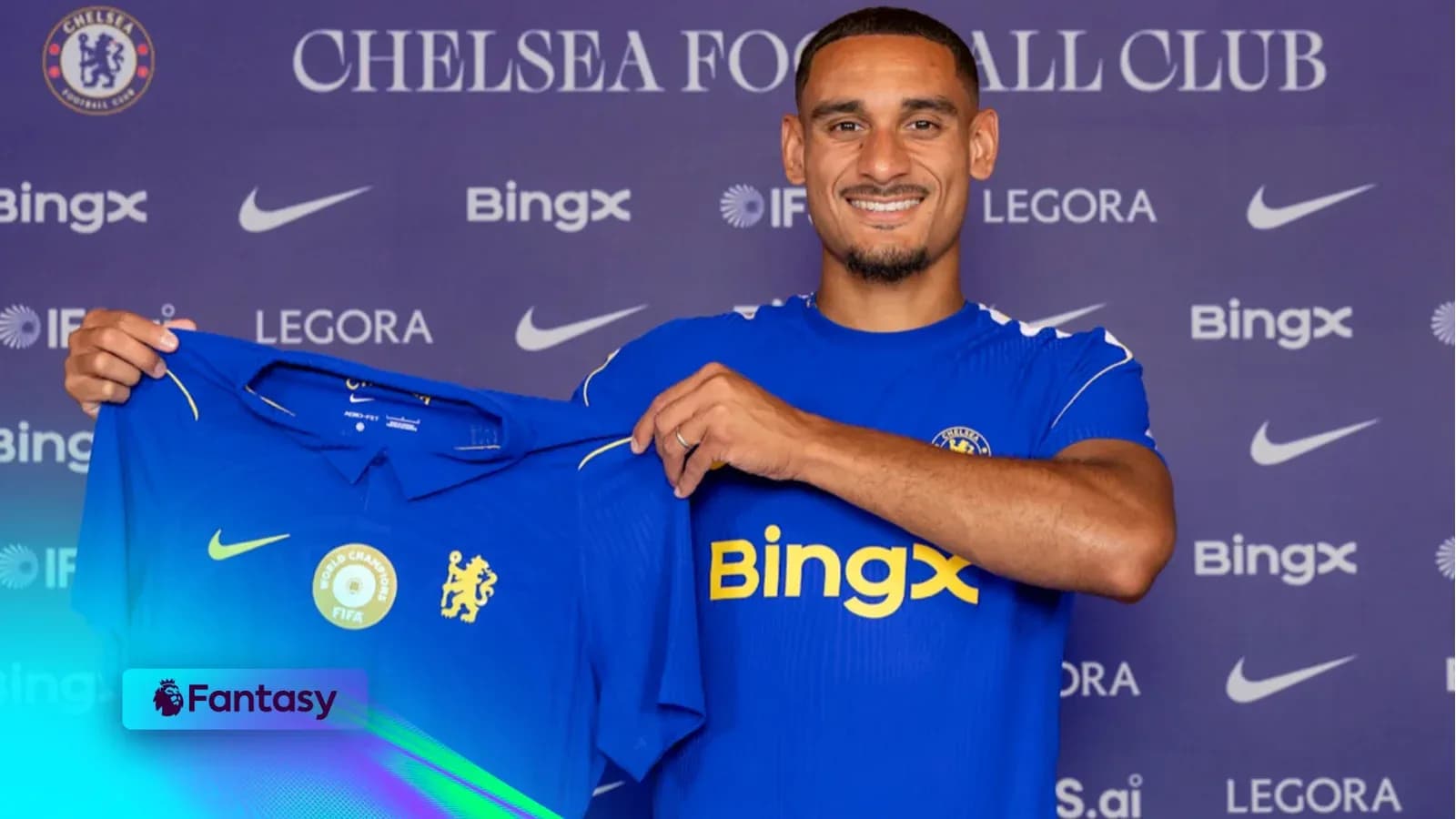 Player holding Chelsea FC jersey at press event