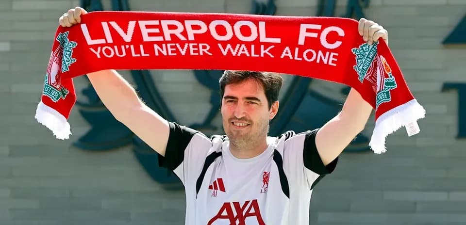 Person holding Liverpool FC scarf outside club