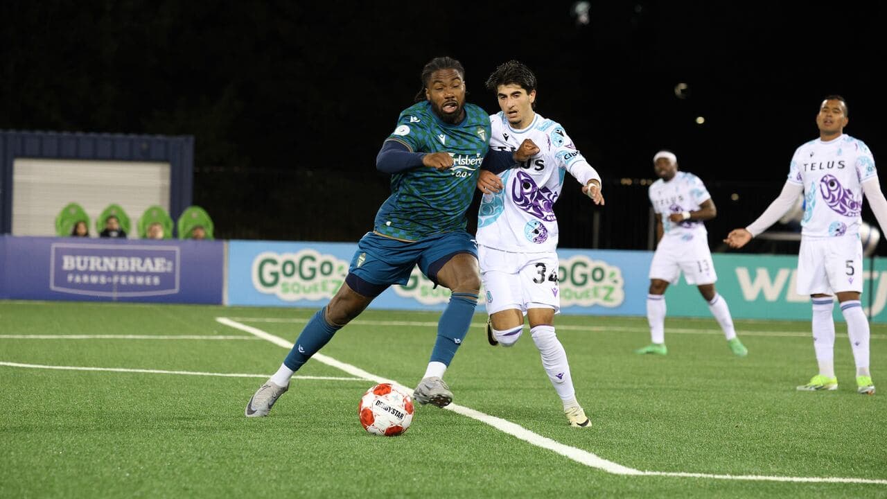 Pacific FC player dribbling past York United defender