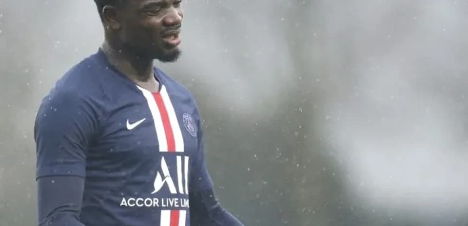 Player in PSG jersey gesturing during training session