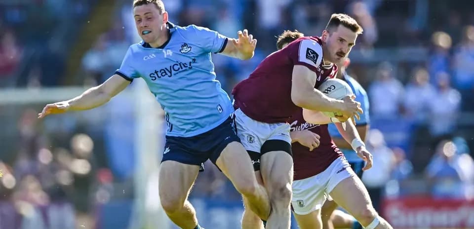 Dublin player tackles Galway player with ball
