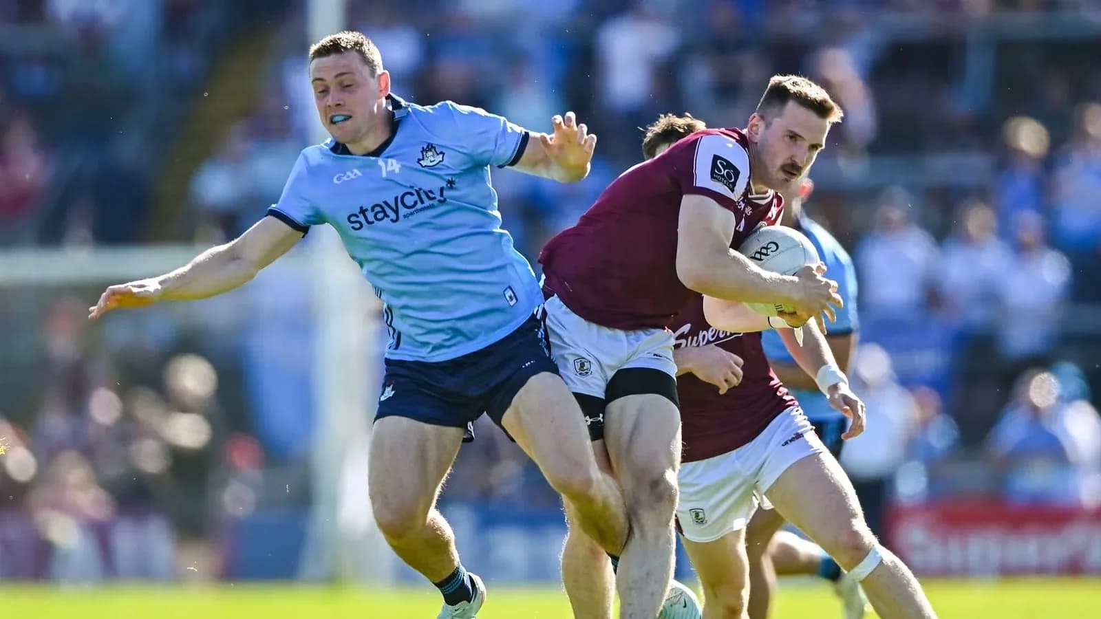 Dublin player tackles Galway player with ball
