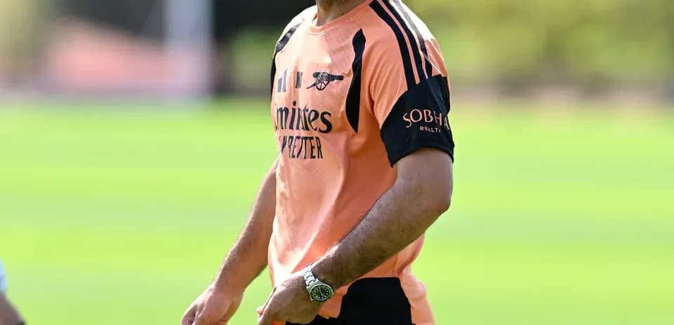 Coach smiling during training session on field