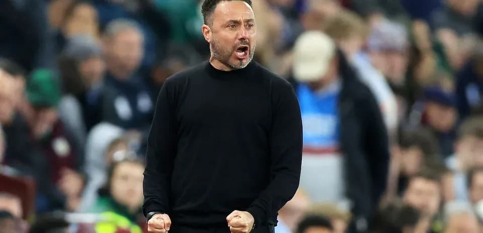 Coach celebrating during a match on the sidelines