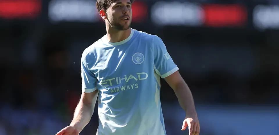 Player in light blue Manchester City jersey on field
