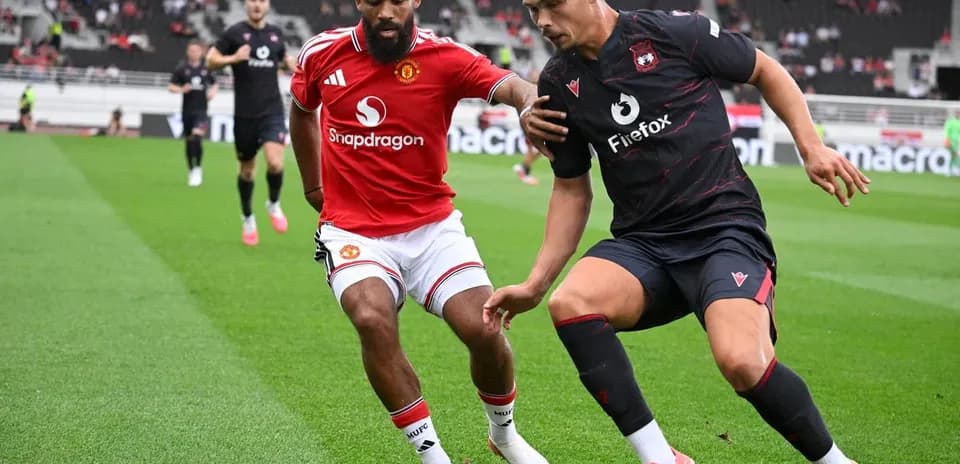 Two players competing for the ball during match