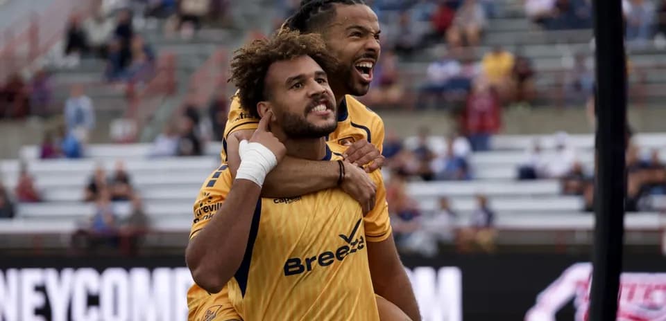 Players celebrating a goal during USL match