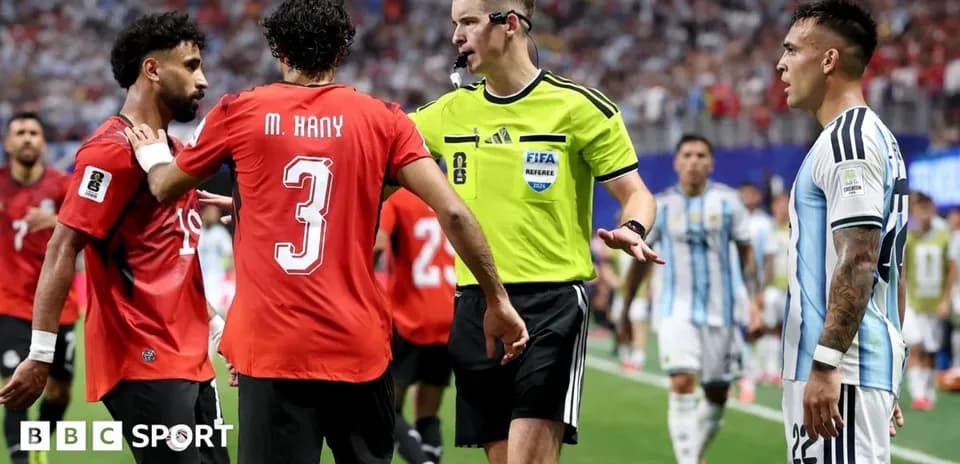 Players and referee discussing during a match