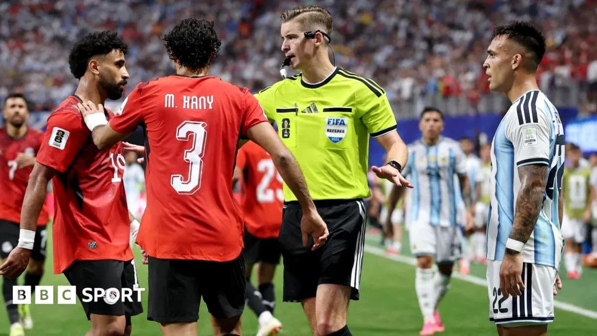 Players and referee discussing during a match