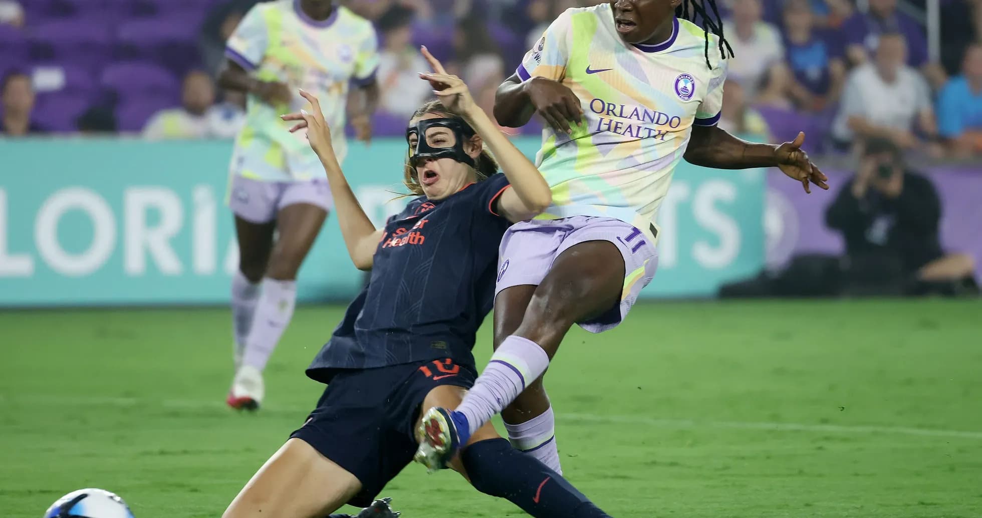 Player tackles opponent during NWSL match