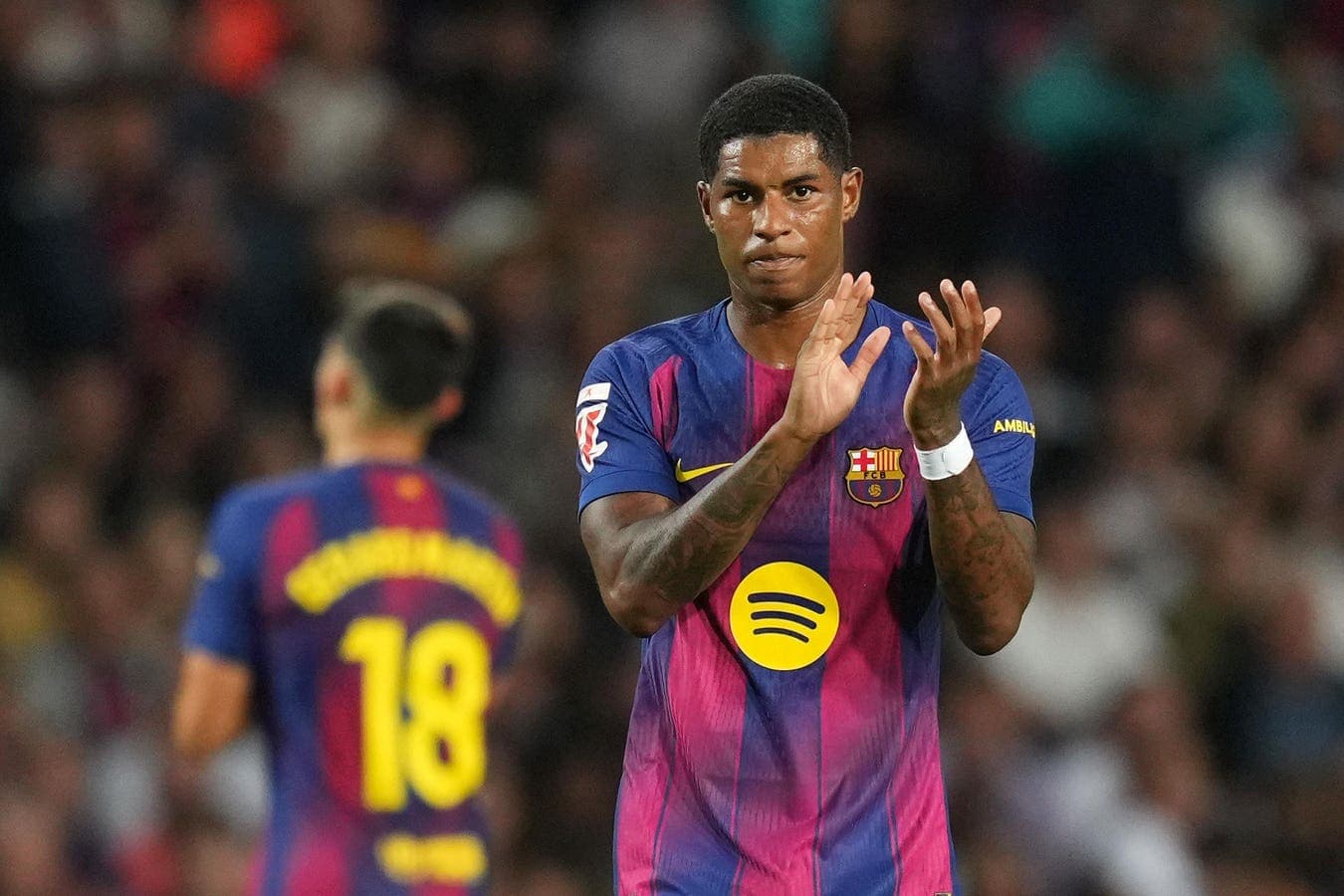 Barcelona player applauding during match on field