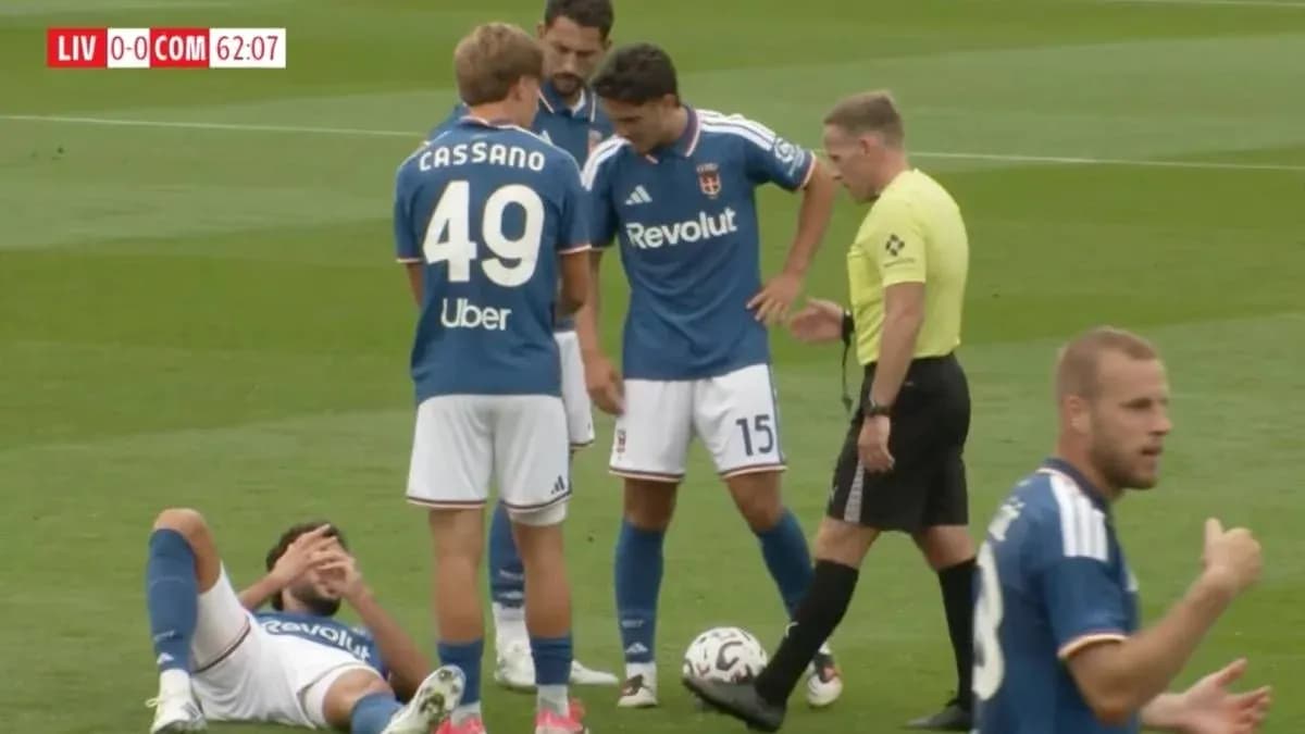 Players gathered around injured teammate on field