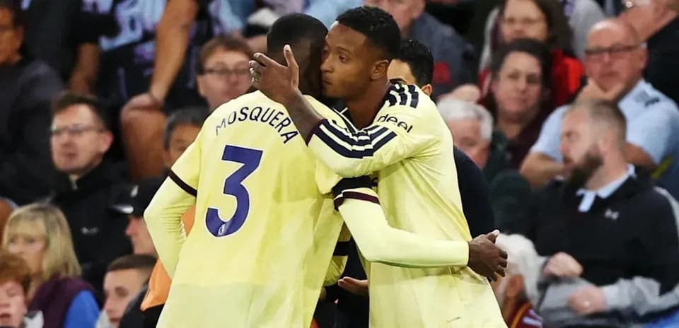 Players embracing on the sideline during match