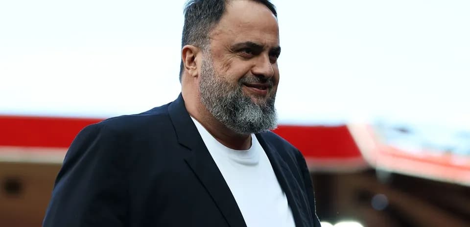 Man with beard walking at stadium entrance