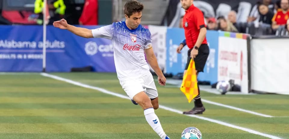 Player preparing to kick the ball during match