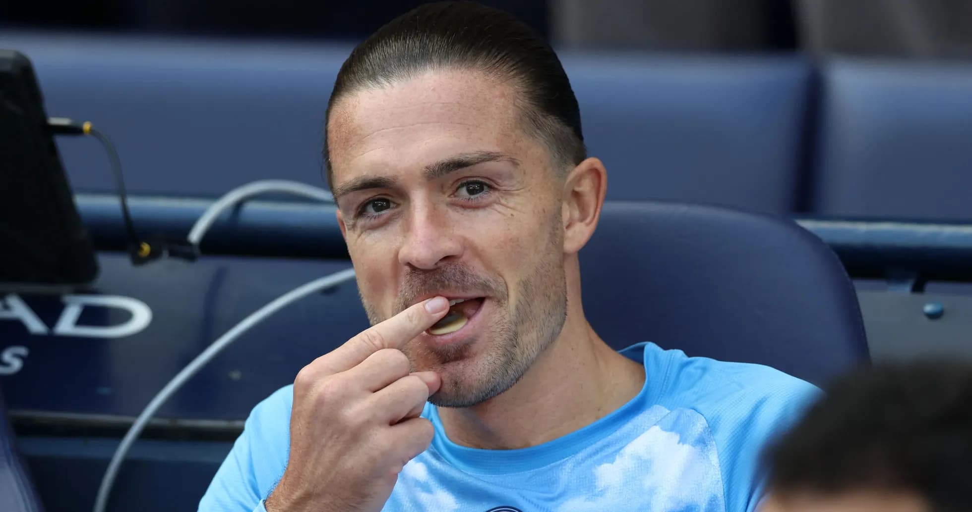 Player sitting on bench eating during match