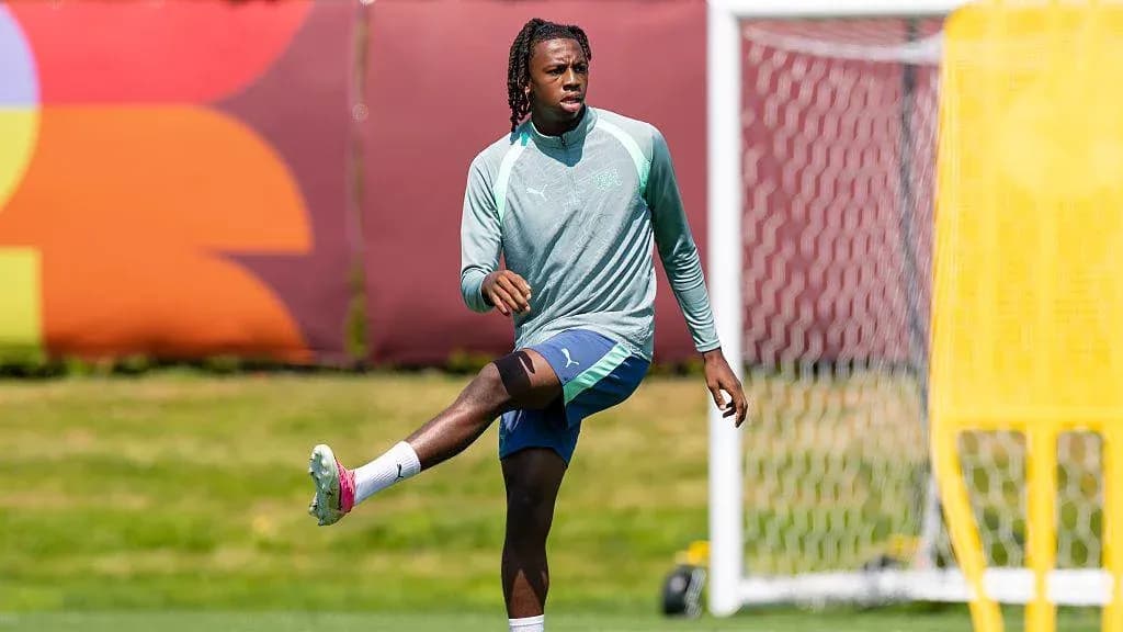 Player stretching during training session on pitch