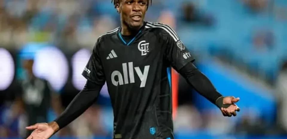 Player in black jersey gesturing during match