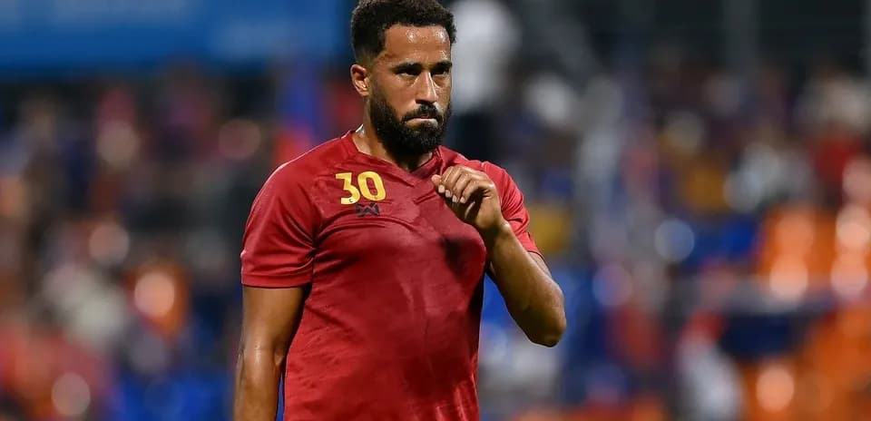 Player in red jersey walking off the field