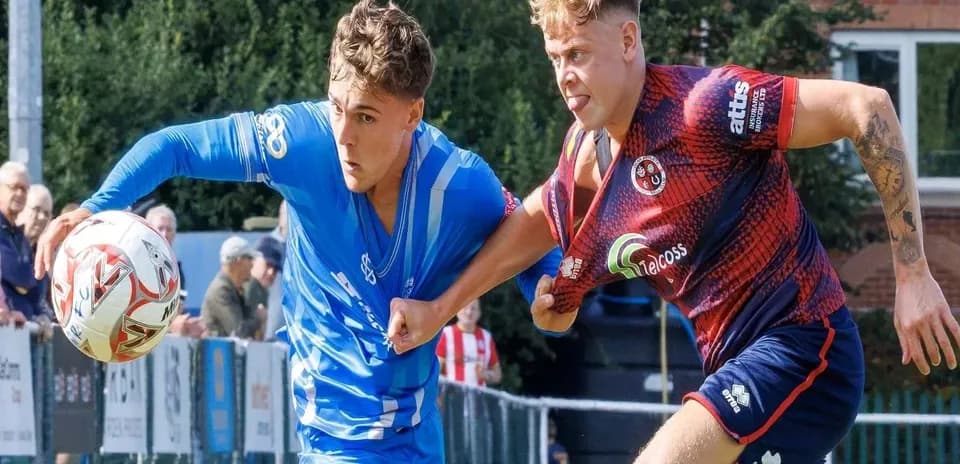 Two players competing for the ball during match