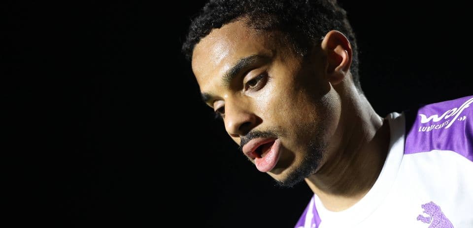 Player in white jersey with purple accents close-up