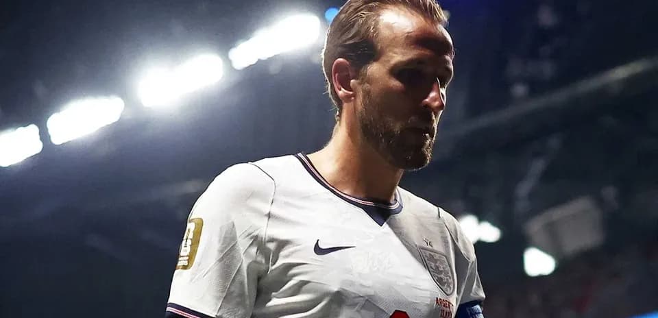 Player wearing England kit walking on the pitch