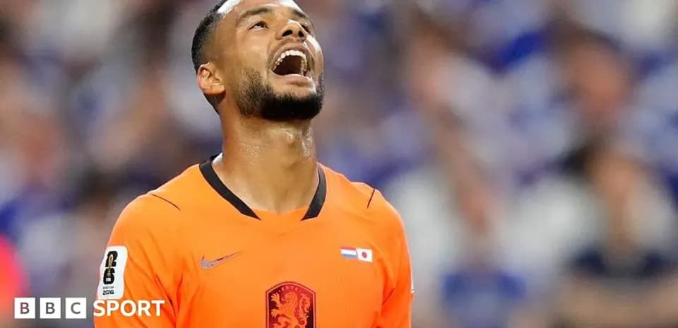 Goalkeeper reacting during a match in orange kit