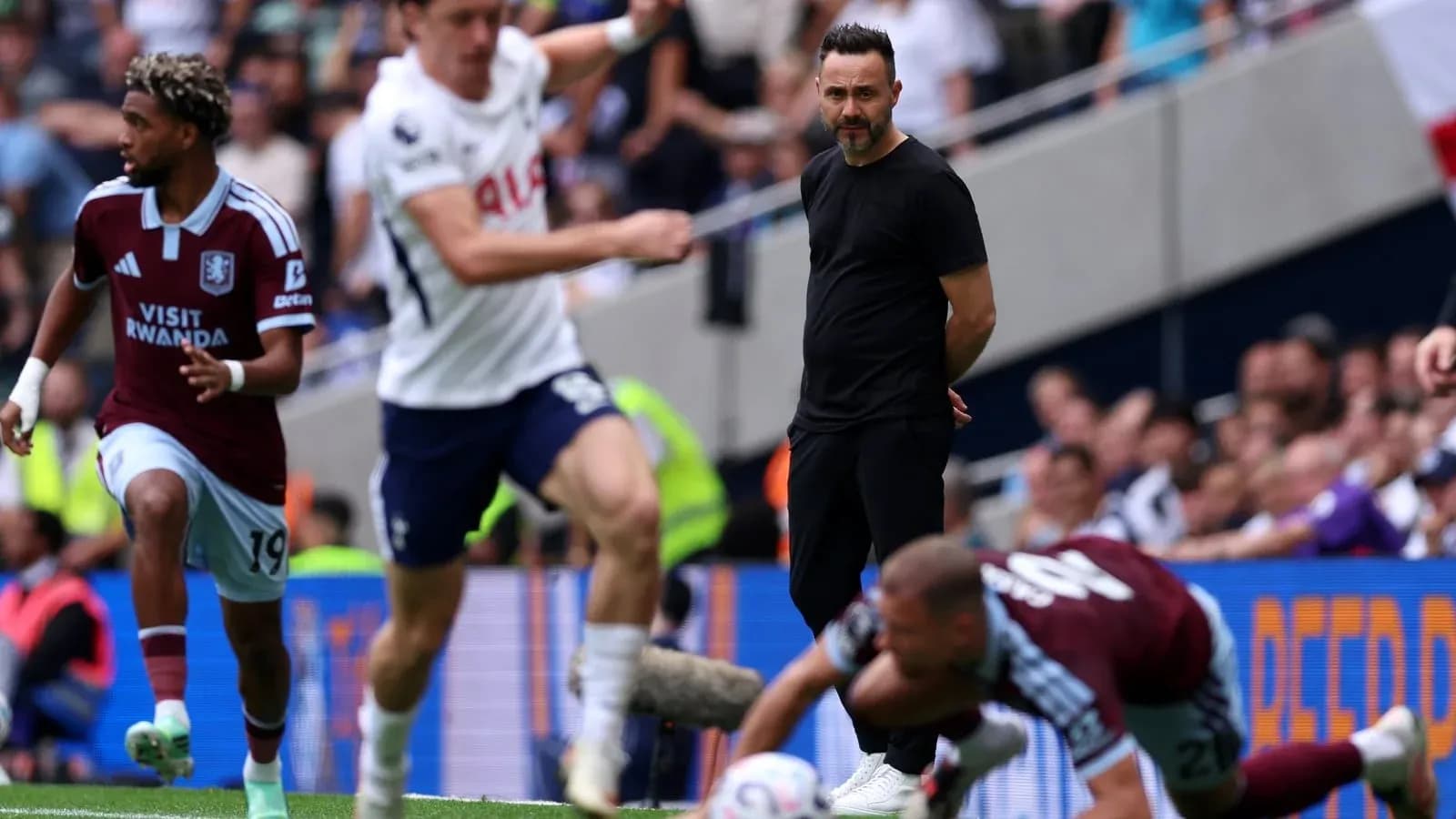 Aston Villa player dribbling past opponent during match
