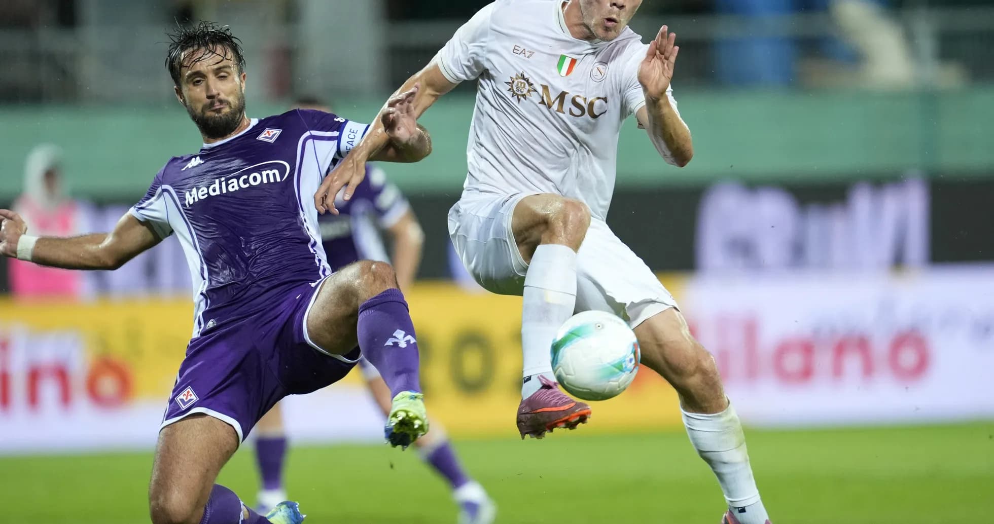 Fiorentina player tackling Napoli opponent