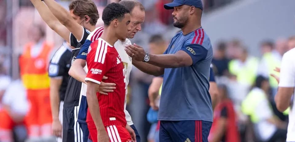 Coach talking to player during match substitution
