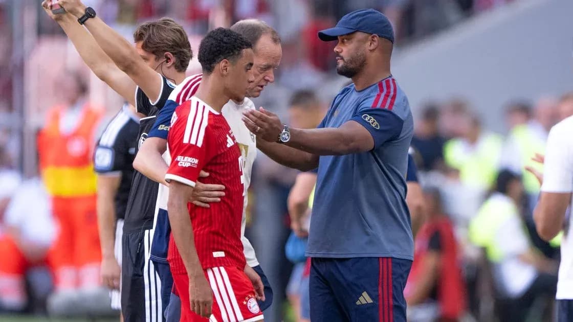 Coach talking to player during match substitution
