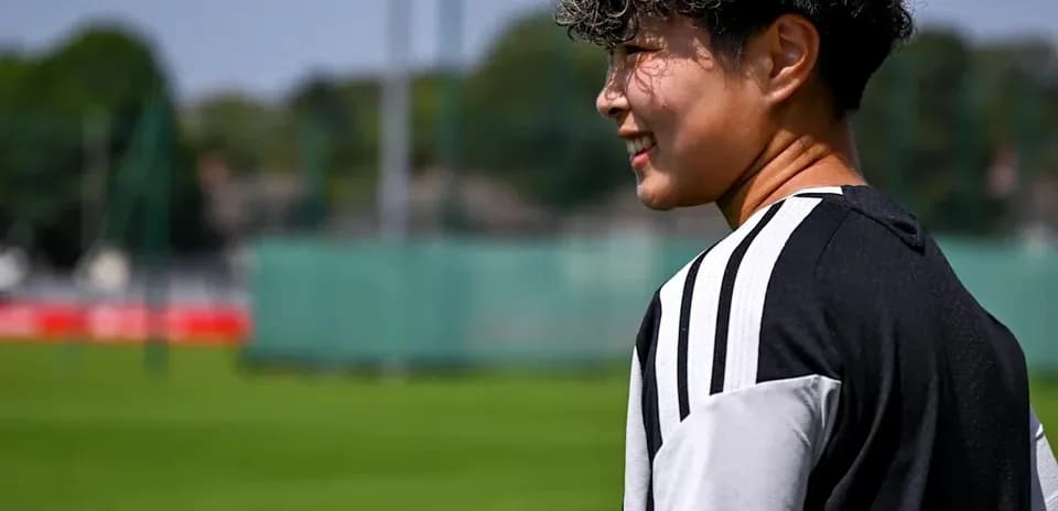 Player walking on training pitch during sunny day