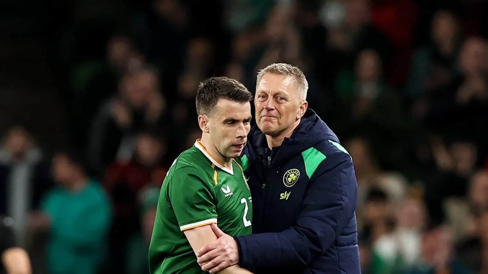 Player and coach embracing during a match