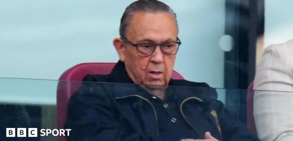 Man sitting in stadium box watching match