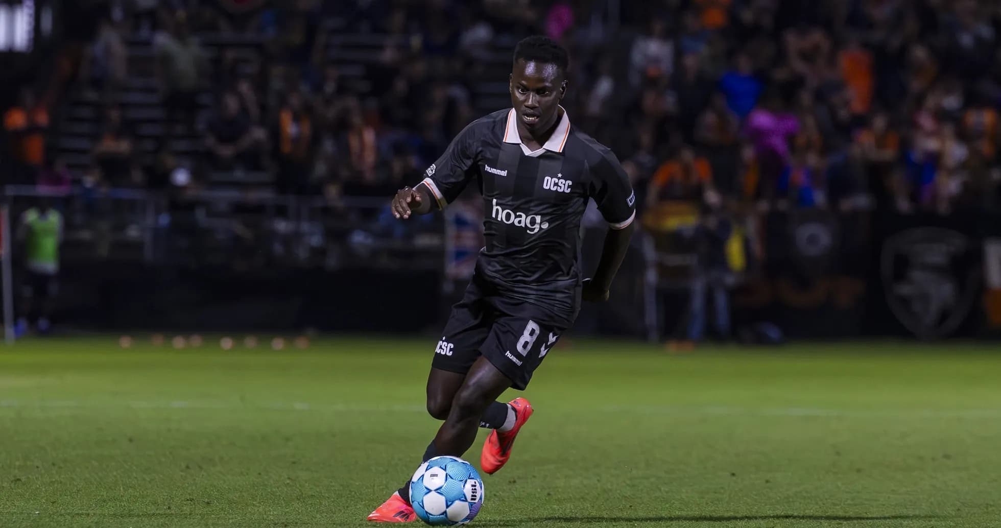 Orange County SC player dribbling the ball
