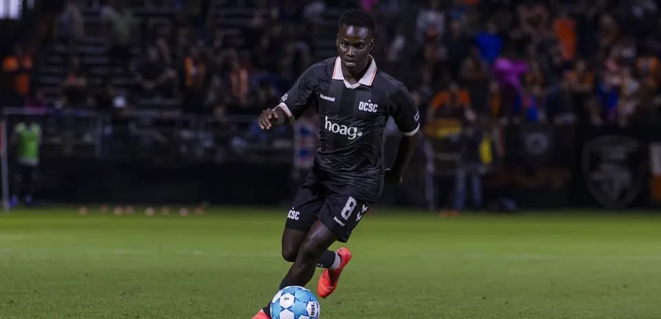 Orange County SC player dribbling the ball