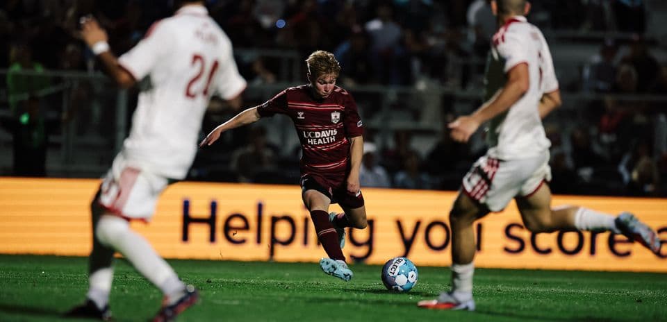 Player dribbling ball during USL Championship match