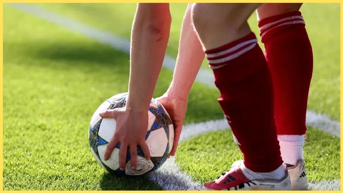 Player placing ball for a set piece on field