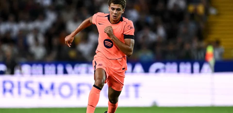 Player running during a football match in bright kit
